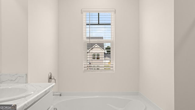 bathroom featuring a bathing tub and vanity