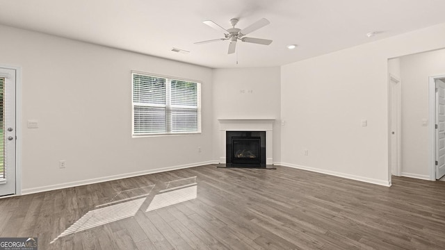 unfurnished living room featuring dark hardwood / wood-style floors and ceiling fan