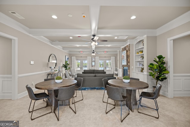 dining area featuring crown molding, ceiling fan, beam ceiling, built in shelves, and french doors