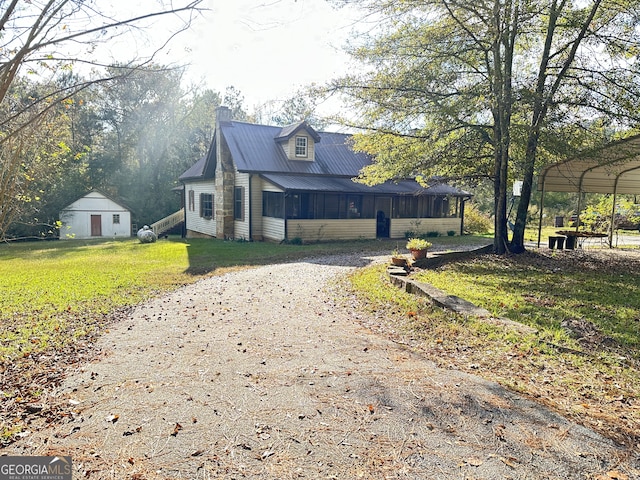 view of side of property with a carport and a lawn