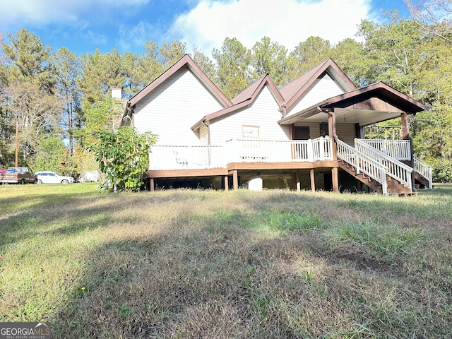 rear view of property with a yard