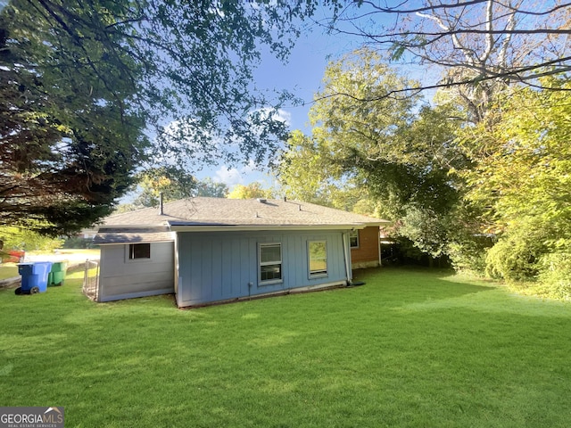 828 Pinevalley Dr, Forest Park, GA 30297 - back of property with a lawn and roof with shingles