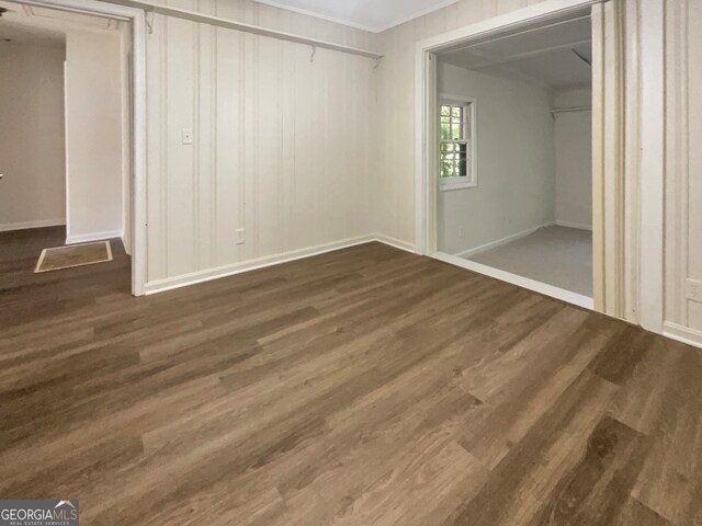 unfurnished bedroom featuring dark wood-type flooring