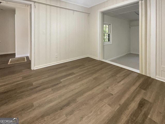 828 Pinevalley Dr, Forest Park, GA 30297 - unfurnished bedroom with dark wood-style floors, ornamental molding, baseboards, and a closet