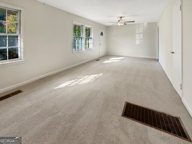 spare room featuring carpet flooring and ceiling fan