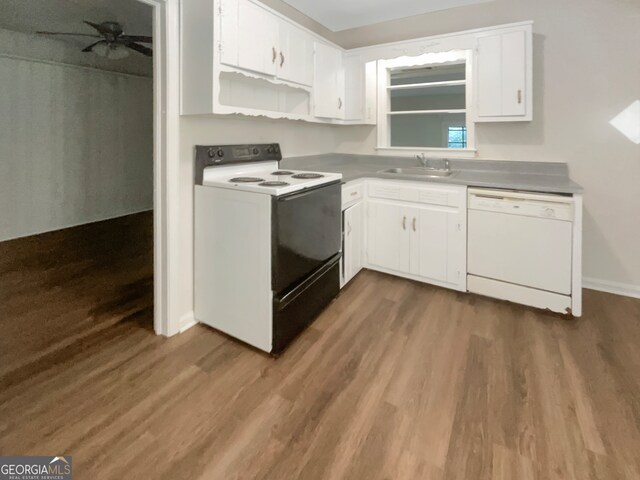 kitchen featuring white appliances, sink, and dark hardwood / wood-style floors