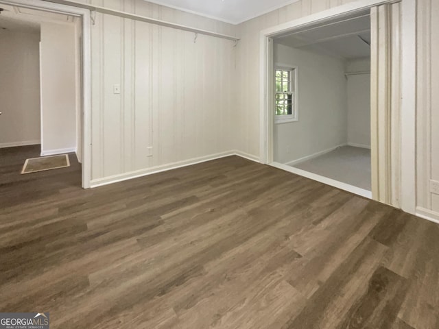 828 Pinevalley Dr, Forest Park, GA 30297 - unfurnished bedroom featuring dark wood-style flooring, baseboards, a closet, and ornamental molding