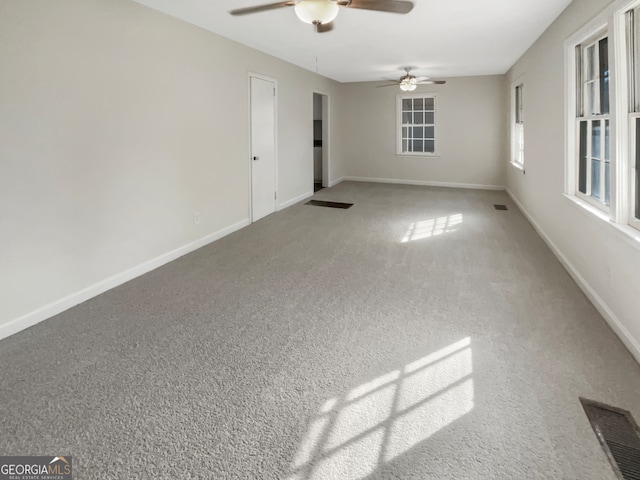 unfurnished room featuring ceiling fan and carpet