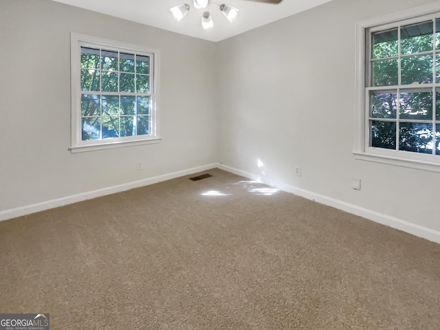 828 Pinevalley Dr, Forest Park, GA 30297 - carpeted empty room featuring healthy amount of natural light, baseboards, and a ceiling fan