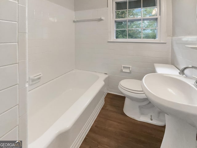 828 Pinevalley Dr, Forest Park, GA 30297 - full bathroom with wood finished floors, tile walls, toilet, wainscoting, and shower / tub combination