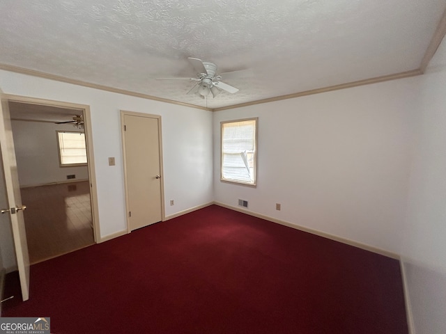 unfurnished bedroom featuring carpet flooring, a textured ceiling, ornamental molding, and ceiling fan