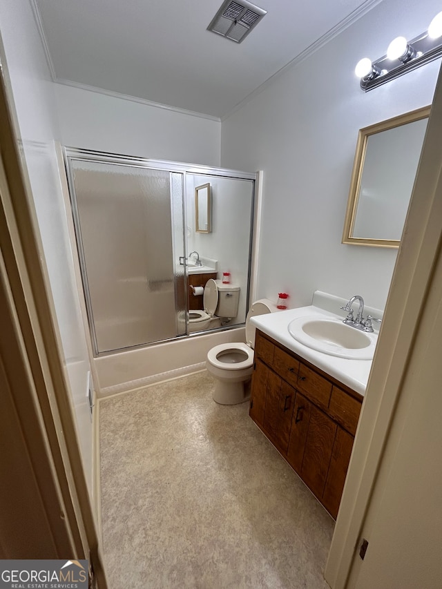 full bathroom with bath / shower combo with glass door, vanity, and toilet