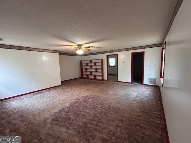 carpeted spare room with a textured ceiling and ceiling fan