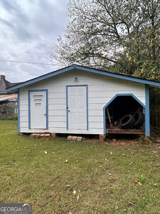 view of outbuilding with a lawn