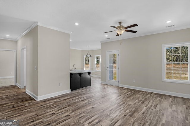 unfurnished dining area featuring dark hardwood / wood-style floors, a chandelier, and crown molding