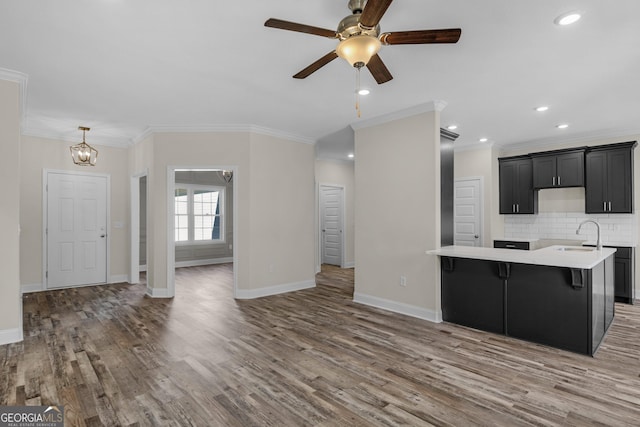 unfurnished living room with dark wood-type flooring, ceiling fan, a healthy amount of sunlight, and crown molding