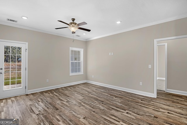 kitchen featuring hardwood / wood-style floors, a textured ceiling, dark brown cabinetry, and ornamental molding