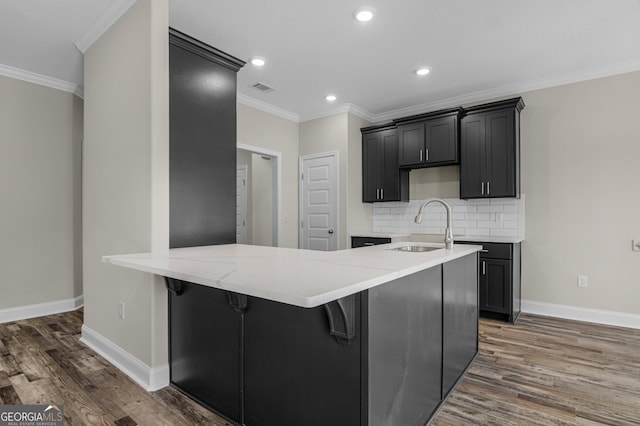 unfurnished dining area with wood-type flooring, ornamental molding, and a textured ceiling