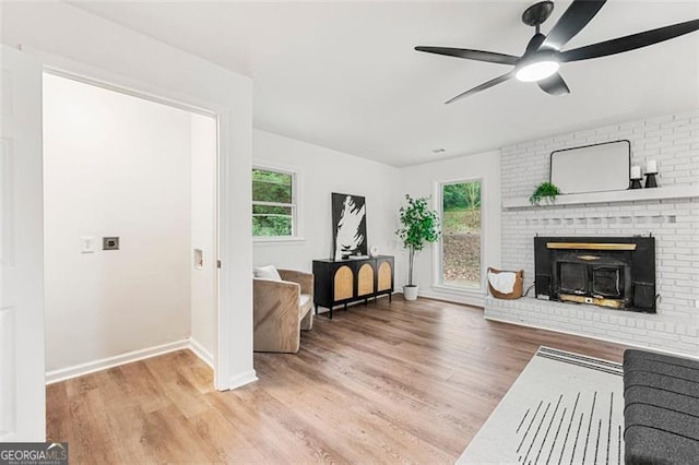 living room with hardwood / wood-style floors, a wealth of natural light, and ceiling fan