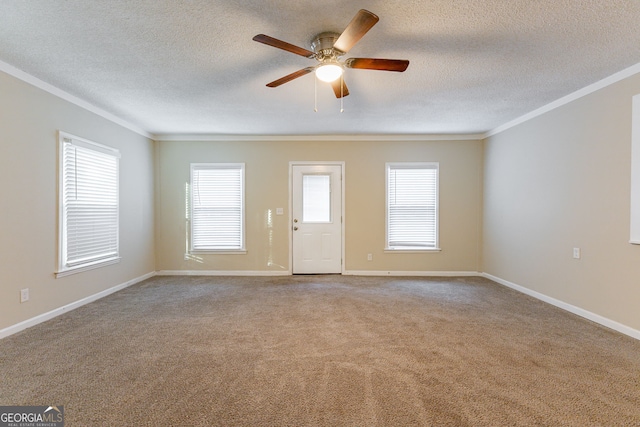 carpeted empty room with ceiling fan, a textured ceiling, and ornamental molding