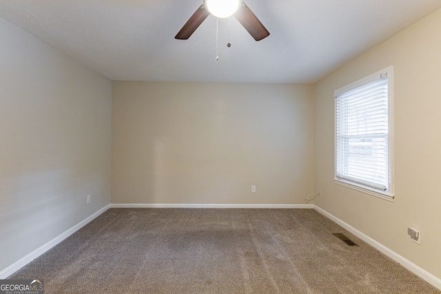 carpeted empty room featuring ceiling fan