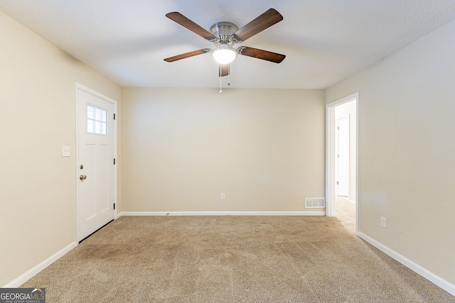 carpeted empty room featuring ceiling fan