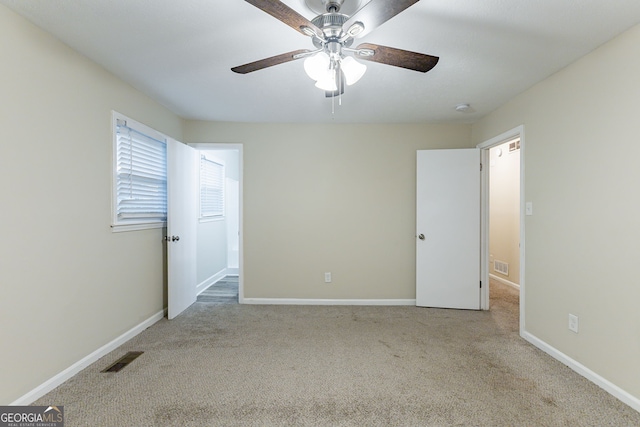 unfurnished bedroom with ceiling fan and light colored carpet