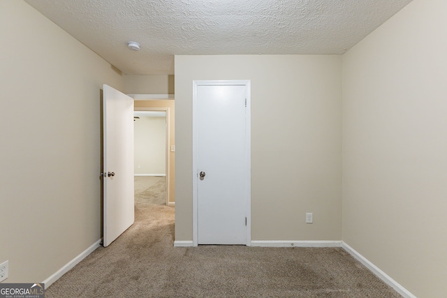 3730 Douglas Ridge Trl, Douglasville, GA 30135 - unfurnished bedroom with carpet floors, a textured ceiling, and baseboards