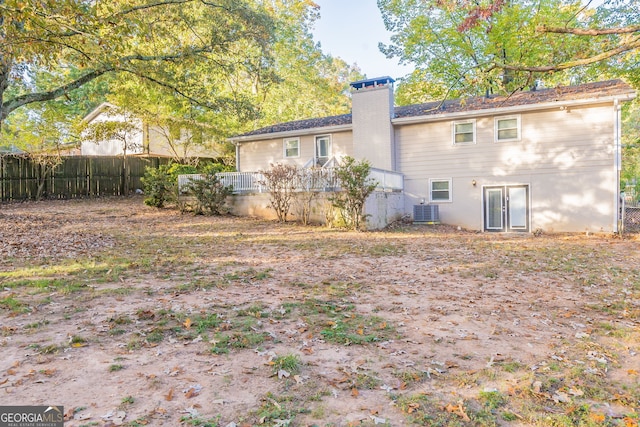 rear view of property featuring central AC unit