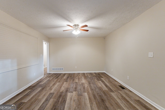 empty room featuring hardwood / wood-style flooring, ceiling fan, and a textured ceiling