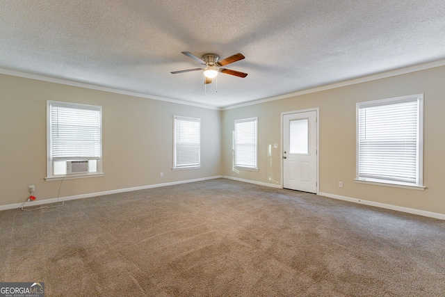 empty room featuring cooling unit, crown molding, a textured ceiling, light carpet, and ceiling fan