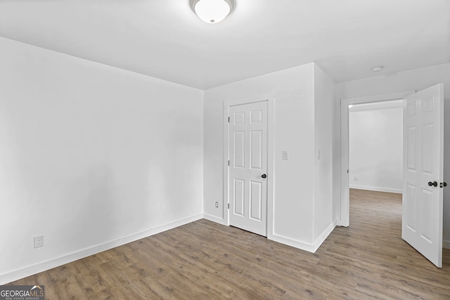 spare room featuring wood-type flooring