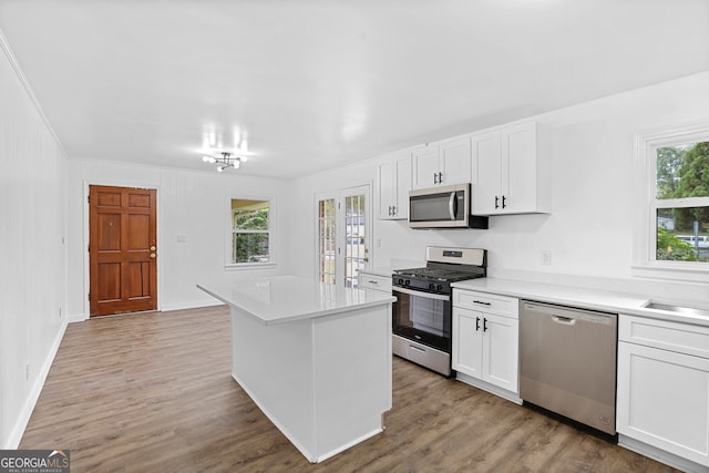 kitchen with plenty of natural light, white cabinetry, and stainless steel appliances