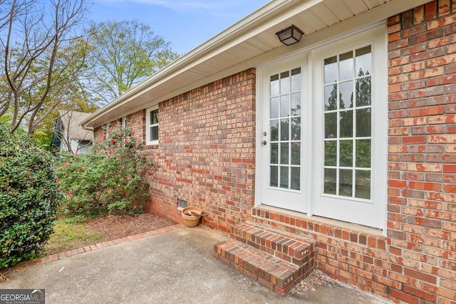 entrance to property featuring a patio area