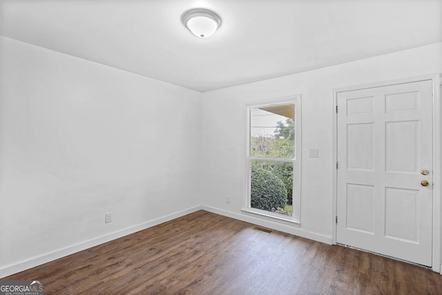 empty room with dark hardwood / wood-style floors