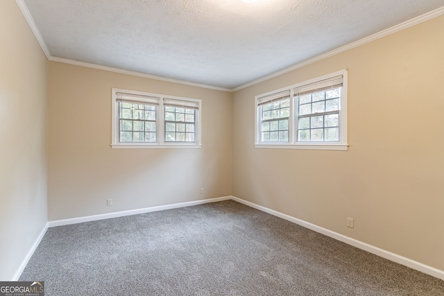 carpeted empty room with plenty of natural light, a textured ceiling, and crown molding