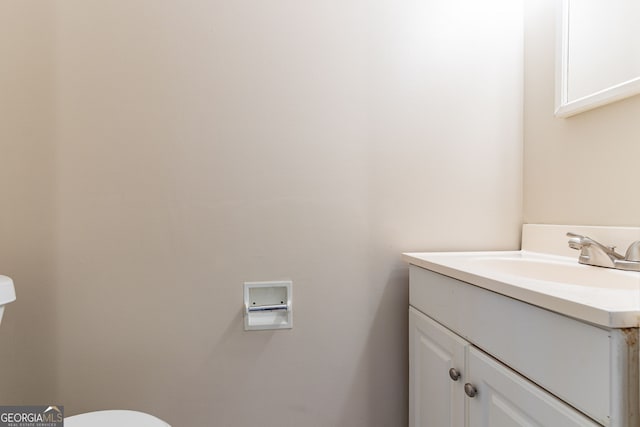 bathroom featuring toilet and vanity