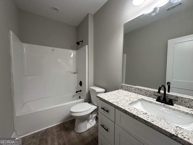 full bathroom with vanity, toilet, washtub / shower combination, and wood-type flooring