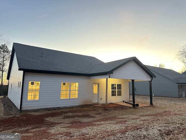 view of back house at dusk