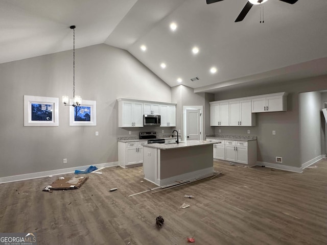 kitchen with white cabinets, appliances with stainless steel finishes, a kitchen island with sink, and sink