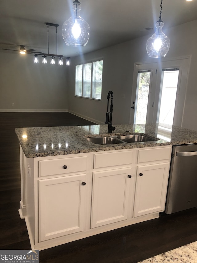 kitchen with white cabinets, stainless steel dishwasher, and pendant lighting