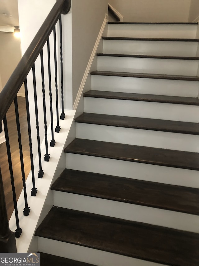 stairway featuring hardwood / wood-style floors