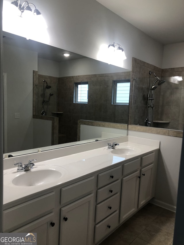 bathroom with vanity, tile patterned floors, and a tile shower