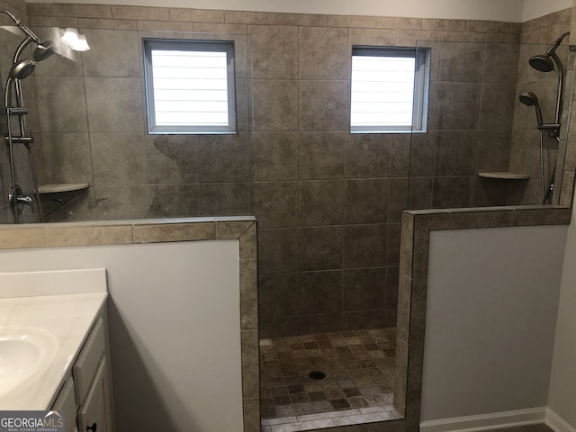 bathroom featuring vanity and a tile shower