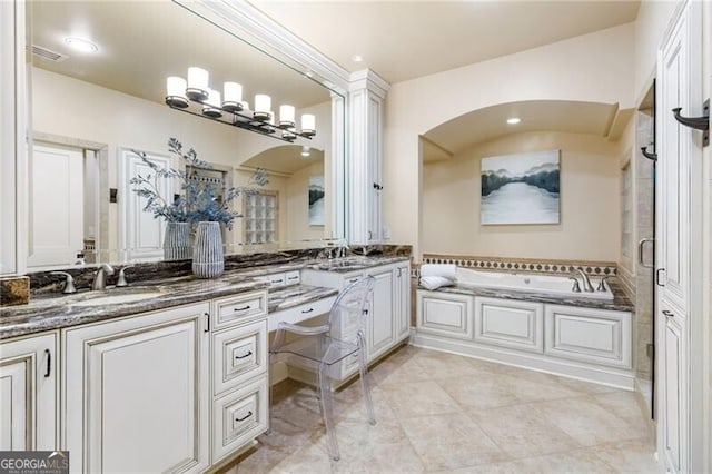 bathroom featuring vanity and a tub