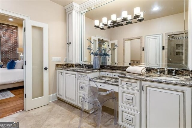 bathroom with vanity, tile patterned floors, and a shower with door