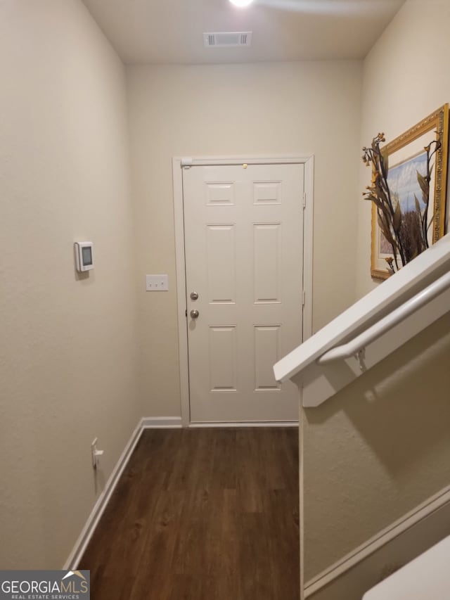 entryway with dark hardwood / wood-style floors