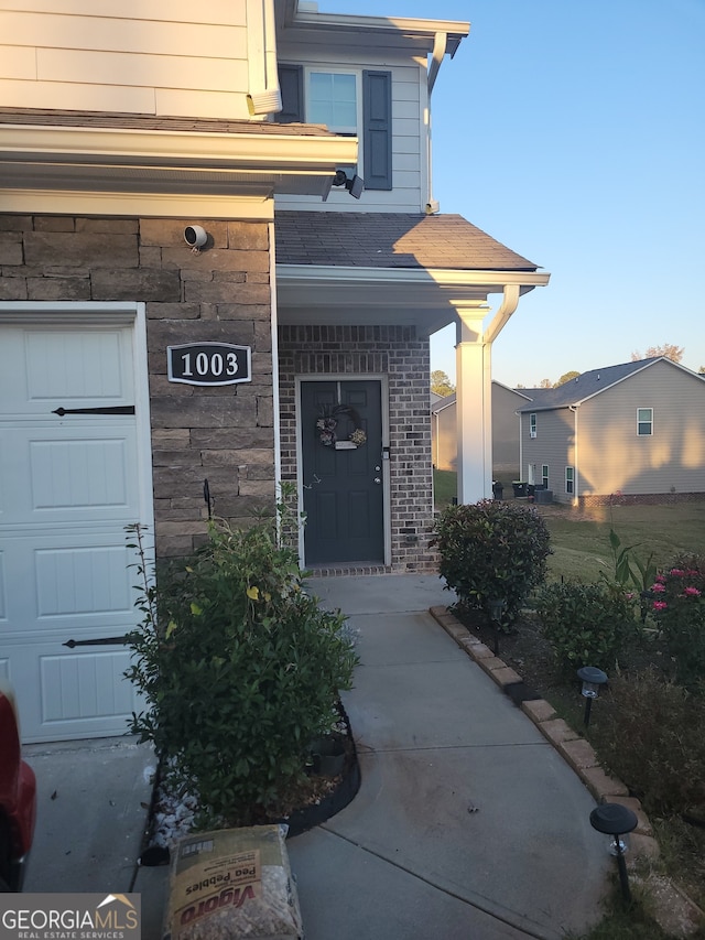 doorway to property with a garage