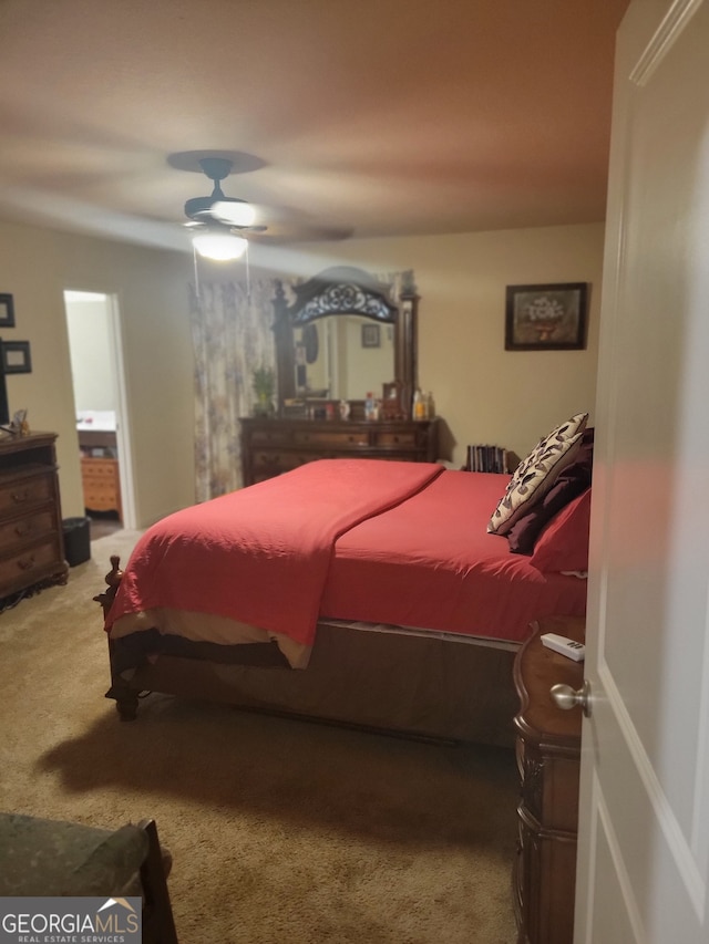 carpeted bedroom featuring ensuite bathroom and ceiling fan