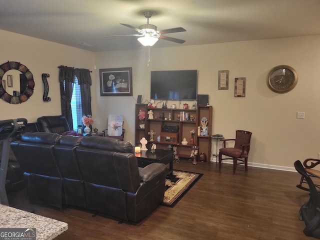 living room featuring ceiling fan and dark hardwood / wood-style floors